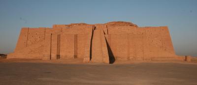 A landscape image of the Ur monument in Iraq. The structure is large and rectangular shaped, sitting against a blue sky.